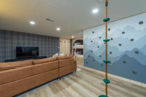 a living room with a couch and a climbing wall at Mountain Views Hot Tub Family Room & Game Room in Swiss