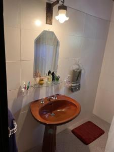 a bathroom with a wooden sink and a mirror at Cabaña para Grupos en Córdoba Piscina y Asador in Yacanto