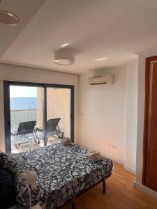 a bedroom with a bed and a view of the ocean at Apartamento en Altea con vistas al mar in Altea
