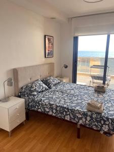 a bedroom with a bed and a view of the ocean at Apartamento en Altea con vistas al mar in Altea