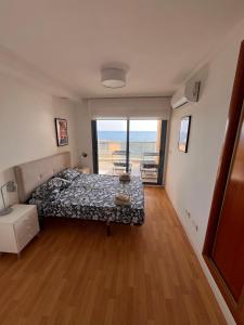 a bedroom with a bed and a view of the ocean at Apartamento en Altea con vistas al mar in Altea