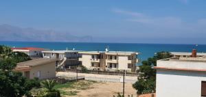 a group of buildings with the ocean in the background at Veranda Sul Beach Di Alcamo Marina in Alcamo Marina