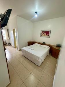 Postel nebo postele na pokoji v ubytování Minas Palace Hotel
