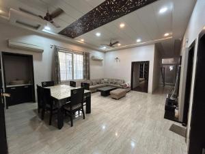 a living room with a table and a couch at Rukmani Kunj in Varanasi