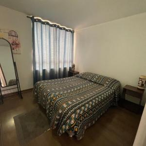 a bedroom with a bed and a large window at Pauwla in Santiago +7 photos