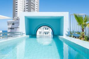 a swimming pool on the roof of a building at The Tropicana Hotel in Cape Town