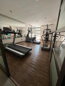 a gym with two exercise bikes and a mirror at Pauwla in Santiago