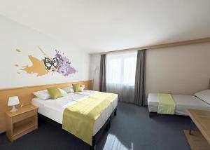 Postel nebo postele na pokoji v ubytování B&B HOTEL Maribor Orel