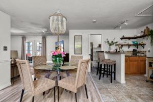 a dining room and kitchen with a table and chairs at Luxury Zen Den with heated pool just off Siesta Key in Sarasota
