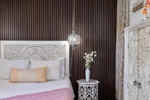 a bedroom with a bed and a vase of flowers at Luxury Zen Den with heated pool just off Siesta Key in Sarasota +28 photos