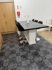 a conference room with a table and chairs at Sangha Hall in Leicester