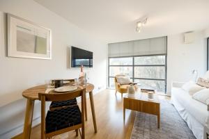 a living room with a table and a couch at Modern Flat, Oxford city centre in Oxford