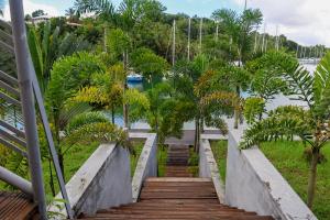 una escalera que conduce al agua con árboles en Villa ÉVASION, en Le Gosier