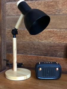 a wooden plunger and a light on a table at Lagoon Bungalows Bali in Nusa Dua
