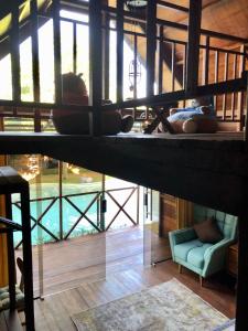 a room with a bunk bed and a pool at Lagoon Bungalows Bali in Nusa Dua