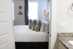 a bedroom with a bed with pillows on it at Chalet Mer in Blue Gulf Beach +51 photos
