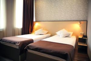 Postel nebo postele na pokoji v ubytování Rondo Hotel