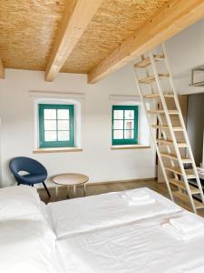 a bedroom with a bed and a ladder at Lagom Home Vipavski Križ in Ajdovščina