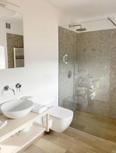 a white bathroom with a sink and a shower at Lagom Home Vipavski Križ in Ajdovščina