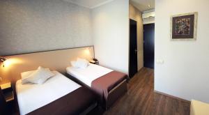 Postel nebo postele na pokoji v ubytování Rondo Hotel