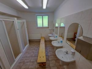 a large bathroom with two sinks and two mirrors at Penzion Betlém in Janske Lazne +41 photos