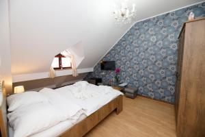 Postel nebo postele na pokoji v ubytování Hotel Panský dům