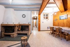 a living room with a fireplace and a table and chairs at Nature l'été et ski l'hiver in Moutiers +13 photos