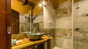 a bathroom with a sink and a shower at Gilad Cabins in Odem
