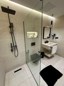 a bathroom with a glass shower and a sink at Centrico 16 Confort & Luxe au Centre in Tangier +9 photos
