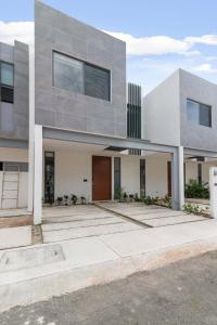 a large gray house with a driveway at Perfect resort style House in Playa del Carmen