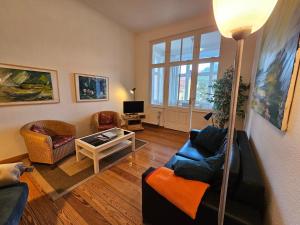 a living room with a couch and a table at Villa Carola - 100 m zum Strand in Bansin