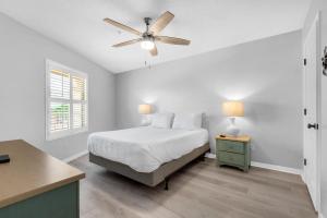 a white bedroom with a bed and a ceiling fan at Maravilla 1309 in Destin +39 photos