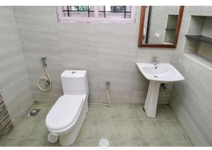 a bathroom with a toilet and a sink at Deep view luxury villa Coffee Cottage Coorg in Madikeri +23 photos