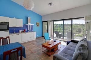 a living room with a couch and a table at Suites Sunny hill in Moncarapacho