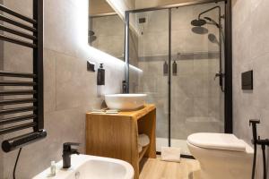 a bathroom with a sink and a toilet and a shower at The Village Chalet in Castel di Sangro +27 photos