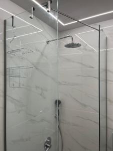 a shower with a glass door in a bathroom at ParkSide Loft in Kalamata