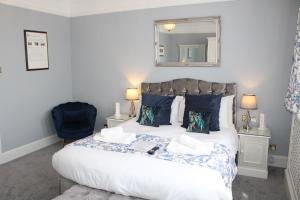 a bedroom with a bed with a mirror on the wall at St Margaret's Hotel in Oxford
