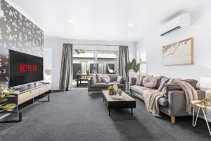 a living room with two couches and a tv at Central 2brm Retreat, Modern, Close to Shopping - By KOSH BNB in Hamilton