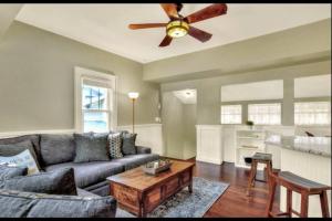 a living room with a couch and a ceiling fan at Charming, cozy, one bedroom apartment in Lakeland