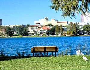 a park bench sitting next to a large body of water at Charming Historic Studio Cottage in Lakeland