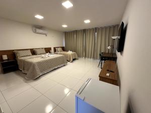 Postel nebo postele na pokoji v ubytování Hotel Formosa - Posto da Mata