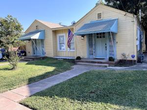 a house with an american flag in front of it at Charming 2-bedroom Cottage in San Antonio