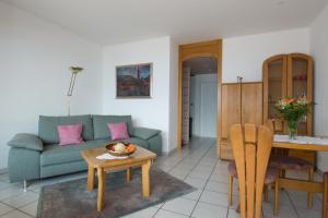 a living room with a couch and a table at Ferienwohnung C07 in Orselina