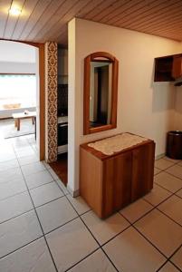 a room with a tub and a mirror on the wall at Ferienwohnung C07 in Orselina +17 photos
