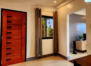 a room with a red door and a window at Villa Mendoza Residence B in San Jose