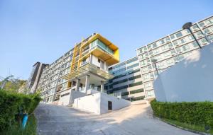a large building with a yellow and white building at Condo near Central Phuket in Ban Ket Ho