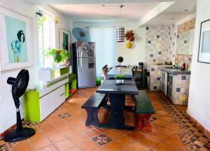 a kitchen with a table in the middle of it at Coccoloba Hotel in Flandes