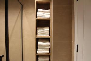 a towel rack with towels in a bathroom at Sun Apartments in Pristina +14 photos