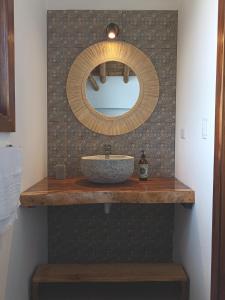 a bathroom with a sink and a mirror on a counter at Casa Flora Ayampe in Ayampe