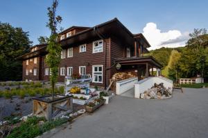 a house with a lot of flowers in front of it at Chata pod Ostrým vrchom in Soblahov